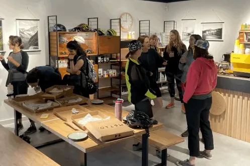 Group talking after pizza night in a bike shop